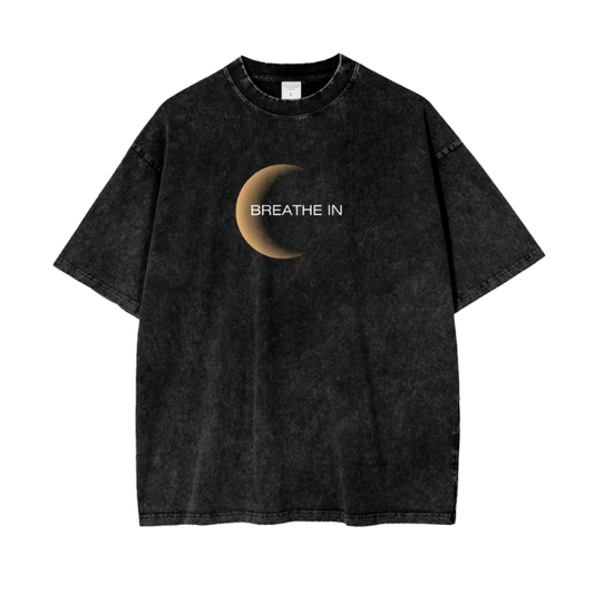 Black t-shirt with a moon graphic and 'Breathe In' text on a white background