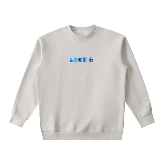 White sweatshirt with 'LUKE 6' printed on it against a white background