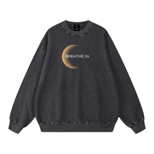 Black sweatshirt with a crescent moon and 'Breathe In' text on a white background