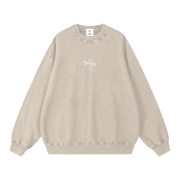 Beige sweatshirt with a small graphic on a white background
