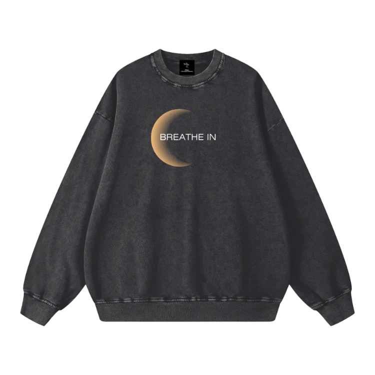 Black sweatshirt with a crescent moon and 'Breathe In' text on a white background