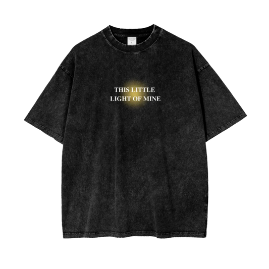 Black t-shirt with text 'THIS LITTLE LIGHT OF MINE' on a white background